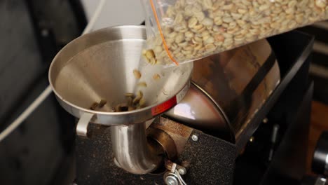 Coffee-Beans-Roasting-Process,-Pouring-Raw-Unroasted-Seeds-Into-Coffee-Roaster-Machine