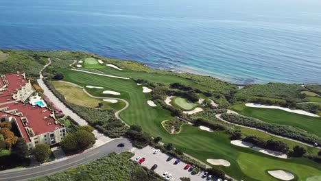Aerial-View-of-Trump-Nation-Golf-Club-in-Rancho-Palos-Verdes,-Los-Angeles,-California-with-the-Pacific-Ocean-in-the-Background-on-a-Warm,-Sunny-Day-with-Perfect-Fairways