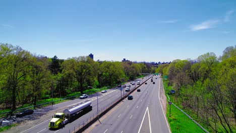 Sunny-view-of-I-87-inBronx-with-a-Mobile-gas-station-sign-and-lush-trees