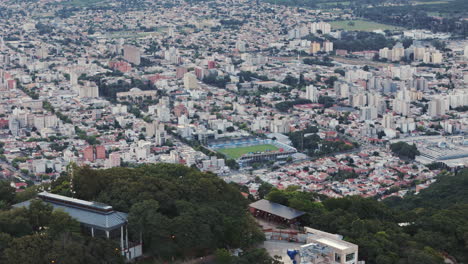 Seguimiento-Aéreo-De-La-Casa-De-Montaña-Sobre-El-Estadio-De-Fútbol-De-La-Ciudad-Capital-De-Salta,-Estadio-El-Gigante-Del-Norte