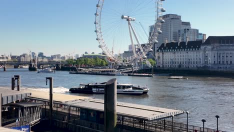 Uber-Boat-Leaving-Westminster-Pier-On-A-Sunny-Morning-With-Ferris-Wheel-In-The-Background-In-London,-UK