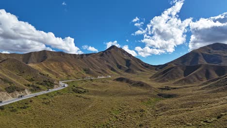 Vehicles-Traveling-On-Lindis-Pass-In-South-Island-Of-New-Zealand