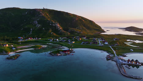 Aerial-tracking-shot-of-traditional-norwegian-homes-on-the-coast-of-North-Norway