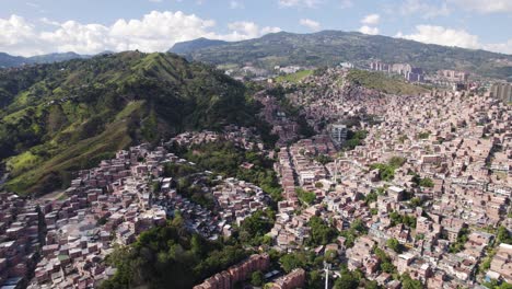 Aerial-view-of-densely-packed-homes-climbing-the-hills-of-Comuna-13-in-Medellin,-Colombia