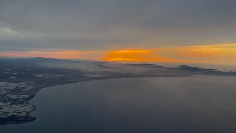 Fire-sunrise-in-Almeria-coast-and-Cabo-de-Gata,-Spain,-shot-from-a-plane-cockpit