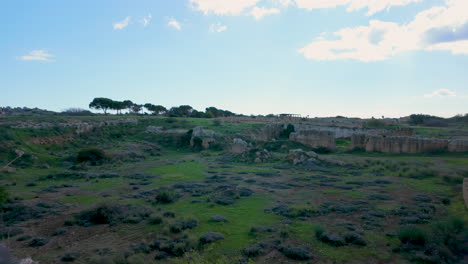 Scenic-view-of-the-Tombs-of-the-Kings-with-the-site's-expansive-ruins-stretching-under-a-dramatic-sky,-emphasizing-the-site's-ancient-grandeur