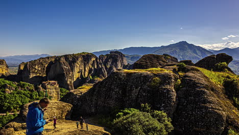 Tourists-taking-pictures-and-hiking-the-famous-rock-pillars-of-Meteora,-Greece---time-lapse