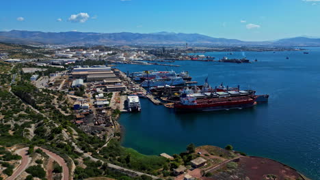 Aerial-view-toward-a-shipyard-port,-sunny-day-in-Elefsina,-Greece