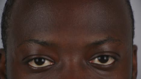 Close-Up-Of-Black-Male-Looking-Up-And-Staring-Into-Camera