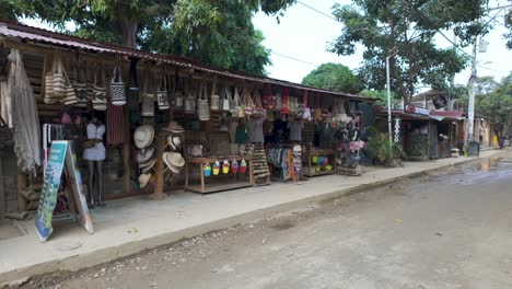 Typical-marketplace-stores-on-dirt-road-in-Palomino-town,-Pan-shot