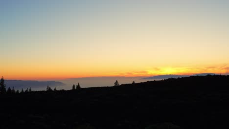 Rear-close-up-shot-of-woman-admiring-sensational-sunset-in-Tenerife-Teide