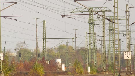 Complex-railway-network-with-intricate-overhead-lines-and-signals,-panning-shot-capturing-the-details-and-structure