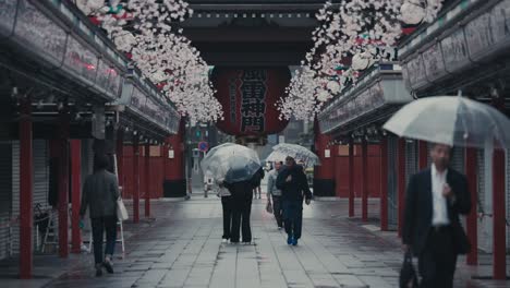 People-With-Umbrellas-At-Nakamise-dori-Street-On-Rainy-Day-In-Tokyo,-Japan
