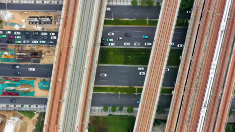 The-Panoramic-View-Electric-Urban-Rail-Train-Rides-On-The-Railway-Bridge-Overpass-The-Highway-With-Car-Vehicles