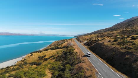 Van-Driving-On-Road-Near-Lake-Pukaki-On-South-Island-Of-New-Zealand