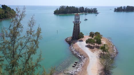 Solitary-lighthouse-on-headland-with-scenic-tropical-beach