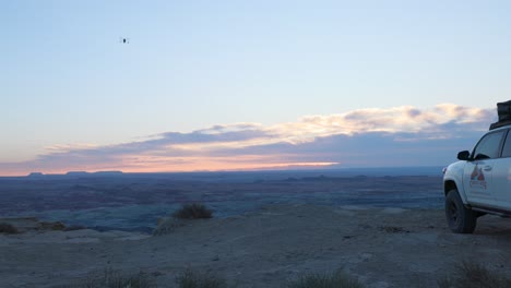 Panoramic-view-of-stunning-clouds-and-desert-overlook-at-Factory-Butte,-Utah-during-sunset-with-drone-operating