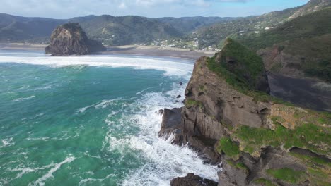 Piha-Beach-–-Starke-Wellen-Schlagen-Gegen-Den-Nun-Rock-Und-Die-Insel-Taitomo-In-Auckland,-Neuseeland