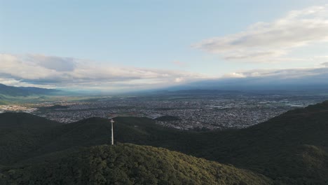Aerial-Of-Antenna-On-Green-Mountains-Surrounding-Capital-City-Of-Salta