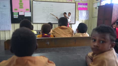 Indonesian-Asian-children-in-class,-teacher-holding-baby-teaching