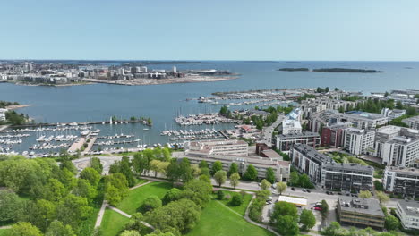 Bird-flying-over-the-Lauttasaari-marina,-in-summer-day-in-Helsinki---Drone-shot