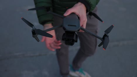 Close-up-shot-of-hands-preparing-DJI-Mavic-3-Pro-propellers-before-flight