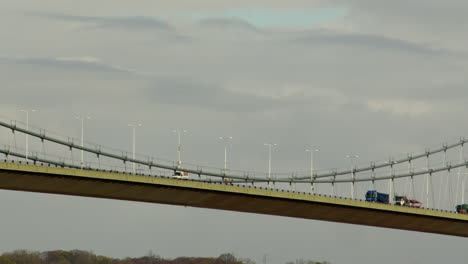 mid-shot-of-traffic-passing-the-midpoint-of-the-Humber-bridge-showing-the-maintenance-gantry