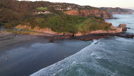 Ocean-Waves-At-The-Muriwai-Beach-With-Black-Sand-In-Auckland,-New-Zealand