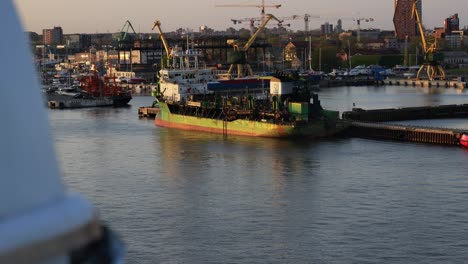 A-green-colored,-strange-looking-ship-of-unknown-purpose-is-moored-at-the-quays-in-the-port-area