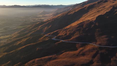 Winding-road-over-the-mountains-of-Crown-Range-to-Cardrona,-New-Zealand