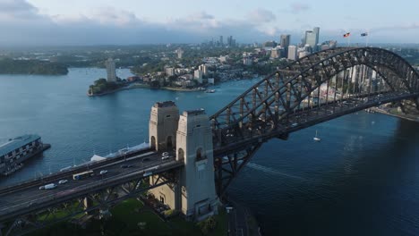 The-Sydney-Harbour-Bridge-,-an-iconic-steel-through-arch-bridge,-with-many-cars-traversing-it