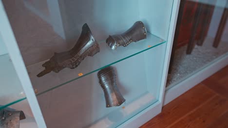Medieval-gauntlets-and-armor-pieces-on-display-in-the-weapon-room-of-Trakošćan-Castle,-Croatia