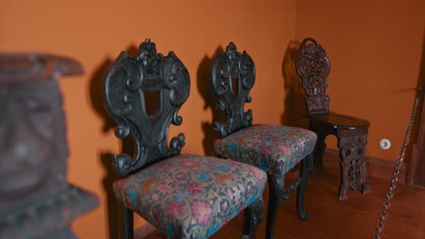 Ornate-carved-chairs-in-Trakošćan-Castle's-Neo-Renaissance-room,-Croatia