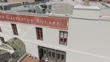 An-aerial-top-down-and-side-view-of-the-Old-Galveston-Square,-built-in-1859,-and-The-Stone-Trumpet-by-David-Adickes,-located-at-23rd-Street-and-The-Strand-in-Galveston,-Texas