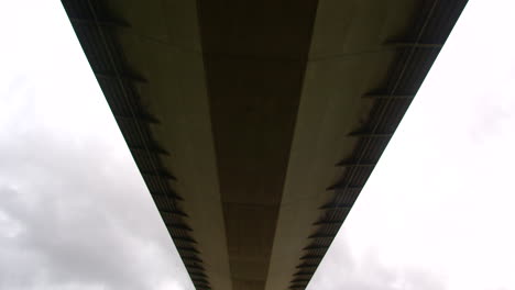 Wide-shot,-tilting-down-from-the-bridge-deck-of-the-Humber-bridge-on-the-south-shore