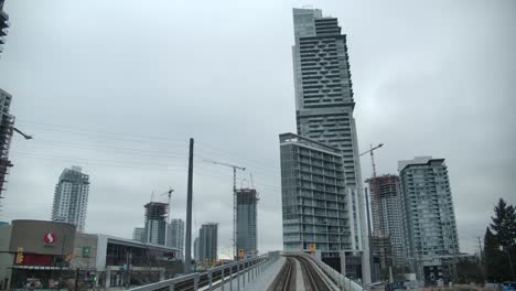 Vista-De-Estructuras-Altas-Desde-Un-Ferrocarril-Elevado-En-La-Ciudad-De-Vancouver,-Columbia-Británica,-Canadá