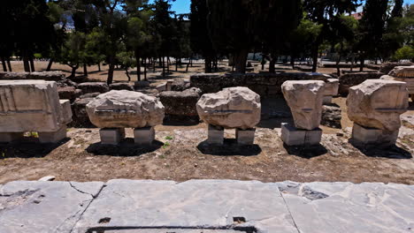 Stone-fragments-of-ancient-civilization-buildings-displayed-in-Athens-acropolis-across-Theatre-of-Dionysus