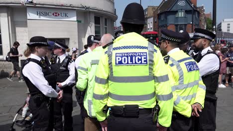 A-group-of-Metropolitan-police-officers-stand-and-take-orders-during-a-public-order-deployment-in-Camden-Town