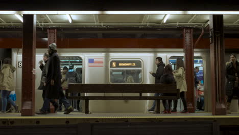 Commuters-Walk-Past-Departing-Subway-Train-at-34th-Street-in-Manhattan-NYC