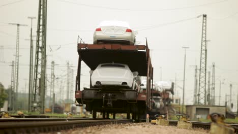 New-cars-loaded-on-a-train-for-transportation-captured-on-a-cloudy-day-at-a-railway-yard