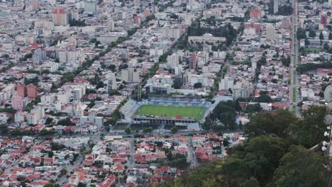 Aerial-Push-Past-Mountain-Top-Antennas-Over-Salta-Capital-City-Of-Argentina-And-Football-Stadium-Estadio-el-Gigante-del-Norte