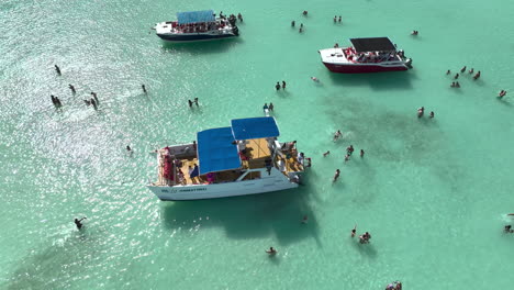Tourists-Swim-On-Turquoise-Sea-Next-To-Their-Tour-Boat-In-Dominican-Republic