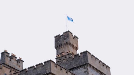Close-up-of-Scottish-flag-flying-on-top-of-Lews-Castle-in-Stornoway,-Outer-Hebrides-of-Scotland-UK