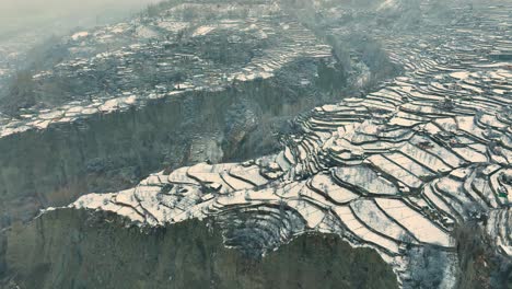 Drone-shot-of-Karimabad-plateau-covered-in-snow-in-Pakistan