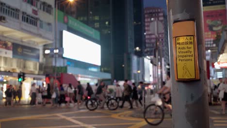 Street-traffic-behind-button-for-assistance-for-visually-impaired,-Hong-Kong