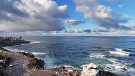 La-Jolla-Cove-Drone-Backwards-Flight-Revealing-Children's-Pool-with-morning-light-and-dramatic-clouds-over-the-ocean