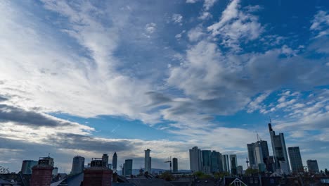 Dramatic-cloudscape-over-Frankfurt-skyline,-timelapse-capturing-day-to-night-transition
