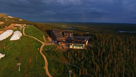 Drone-approaching-the-Hotel-Levi-Panorama,-summer-evening-in-Lapland,-Finland