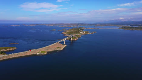Panoramic-drone-shot-around-the-Atlantic-ocean-road,-sunny,-summer-day-in-Norway