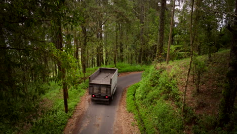Rural-forest-location,-mountain-road-travelled,-freight-lorry-driven